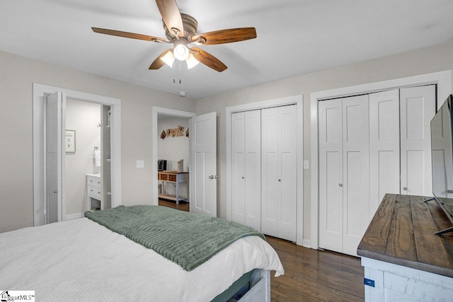 bedroom with multiple closets, dark hardwood / wood-style floors, and ceiling fan