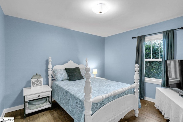 bedroom with dark hardwood / wood-style floors