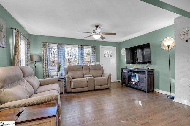 living room with dark hardwood / wood-style floors and ceiling fan