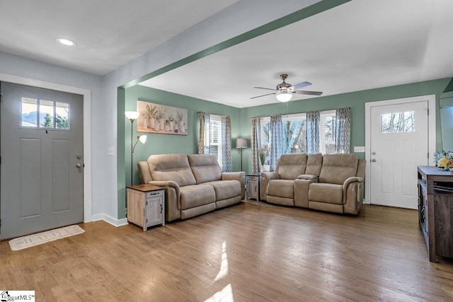 living room with ceiling fan and wood-type flooring