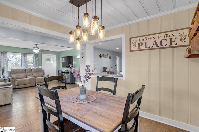 dining room featuring hardwood / wood-style flooring, ceiling fan, and ornamental molding