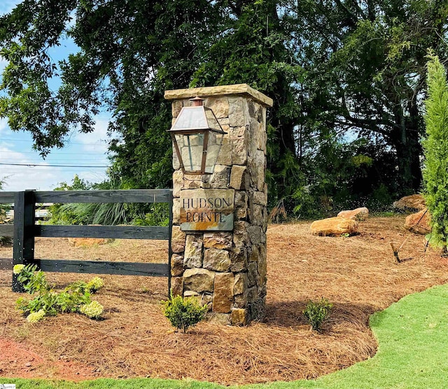 community sign with a carport and fence