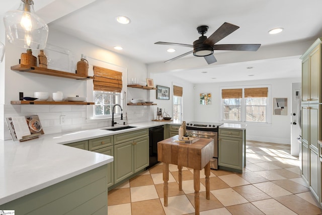 kitchen featuring sink, tasteful backsplash, black dishwasher, green cabinets, and stainless steel electric stove