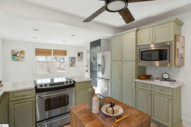 kitchen with appliances with stainless steel finishes and green cabinetry