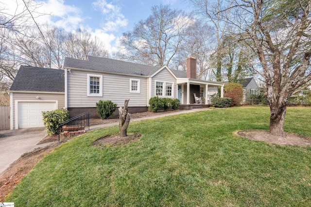 ranch-style home featuring a garage, a front yard, and covered porch