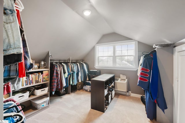 walk in closet featuring light colored carpet and lofted ceiling