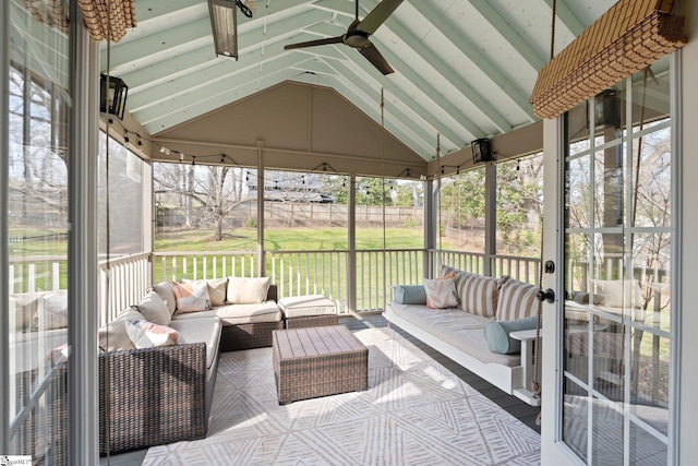 sunroom / solarium featuring lofted ceiling and ceiling fan