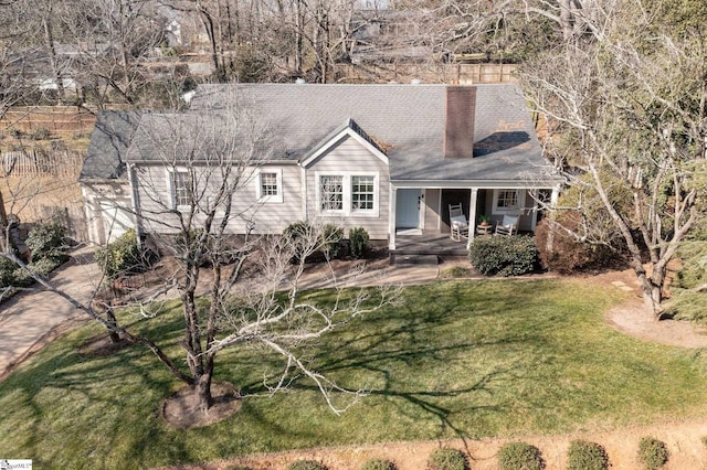 ranch-style house featuring a front yard and covered porch