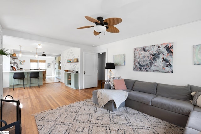 living room with ceiling fan and light wood-type flooring