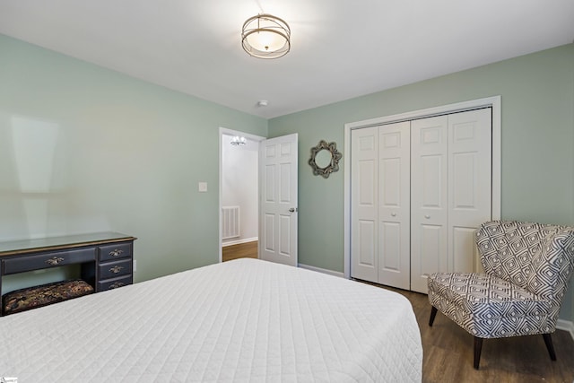 bedroom with dark wood-type flooring and a closet