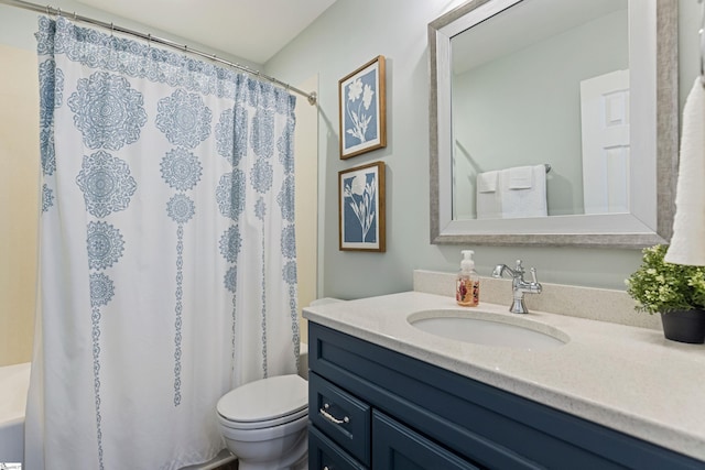 bathroom featuring vanity, a shower with shower curtain, and toilet