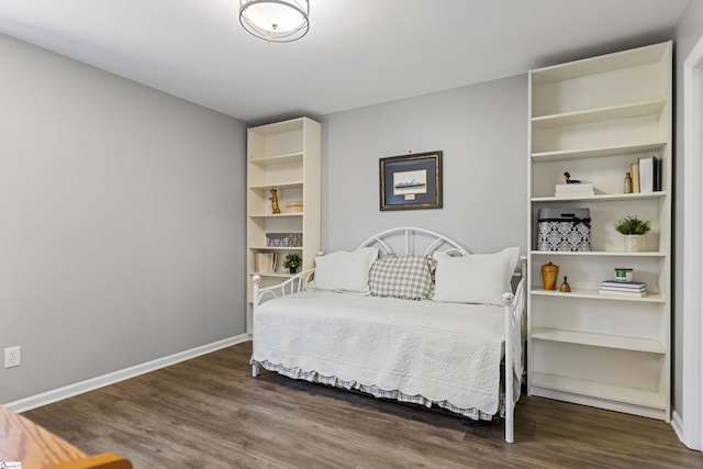 bedroom with dark wood-type flooring