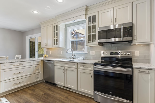 kitchen with dark wood-type flooring, appliances with stainless steel finishes, sink, and light stone counters