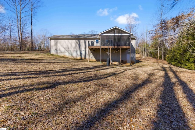 back of property with a sunroom