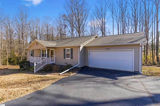 single story home featuring a garage and covered porch