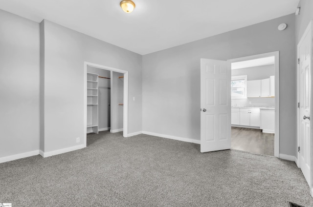 unfurnished bedroom featuring carpet floors and a closet