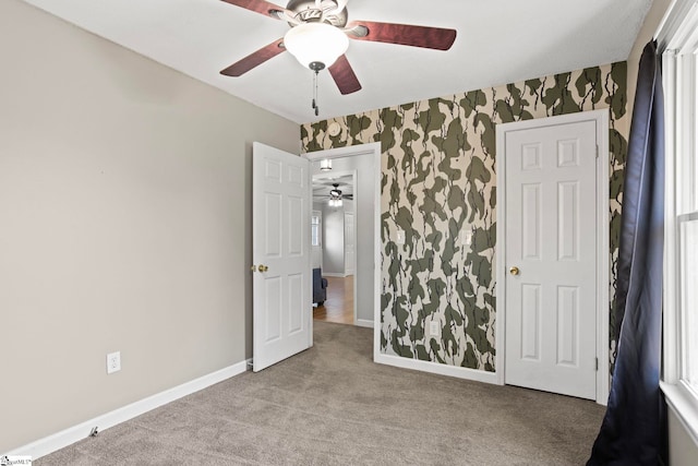 unfurnished bedroom with light carpet and ceiling fan