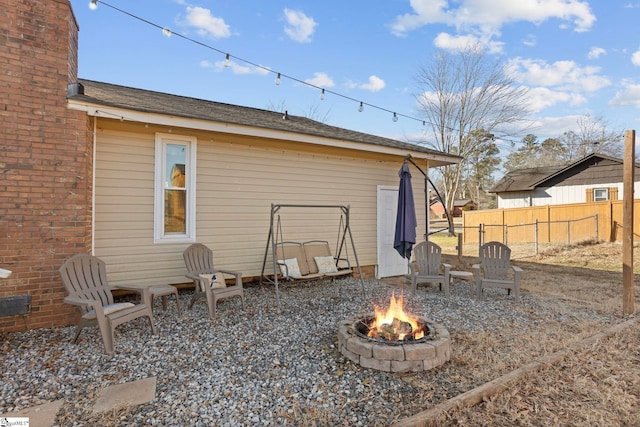 rear view of house featuring an outdoor fire pit