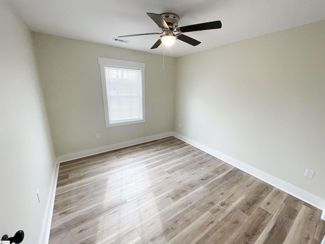 spare room with light hardwood / wood-style floors and ceiling fan