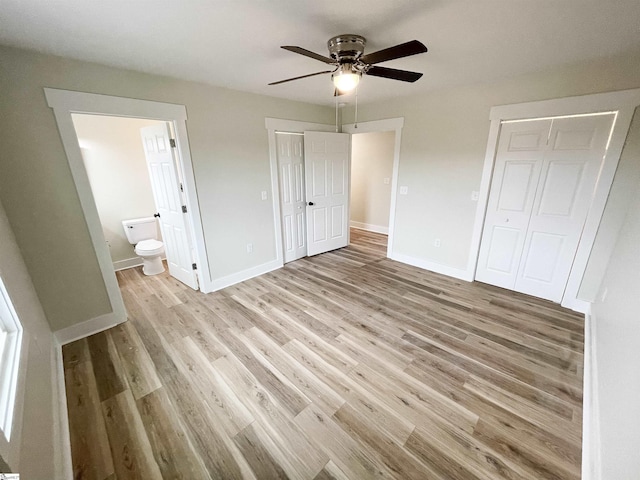 unfurnished bedroom featuring ceiling fan, a closet, ensuite bath, and light hardwood / wood-style flooring