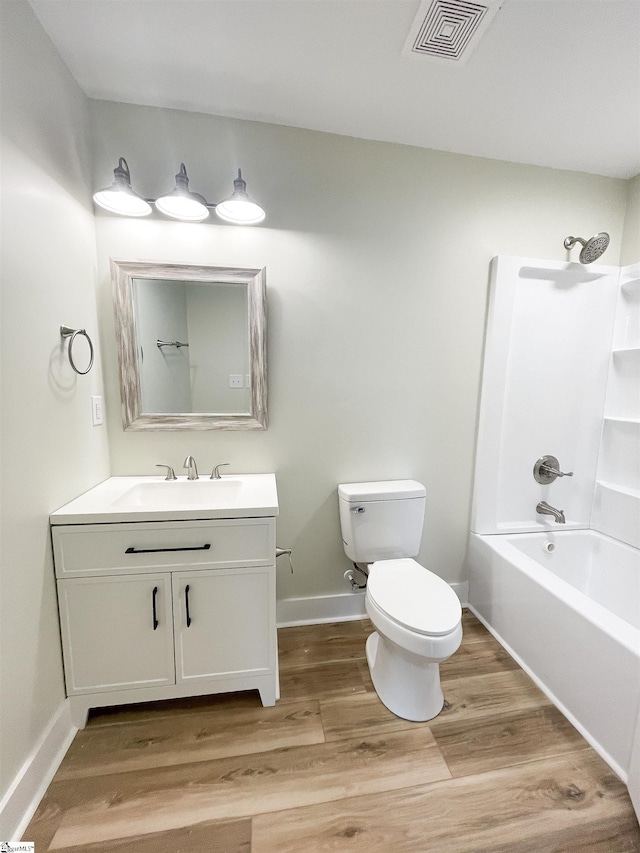 full bathroom featuring shower / tub combination, wood-type flooring, vanity, and toilet