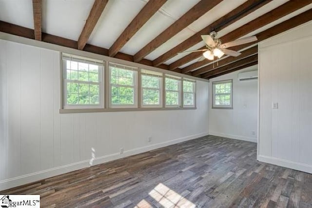 unfurnished room featuring ceiling fan, dark hardwood / wood-style flooring, lofted ceiling with beams, and a wall unit AC