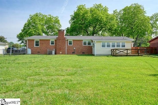 rear view of property featuring a yard