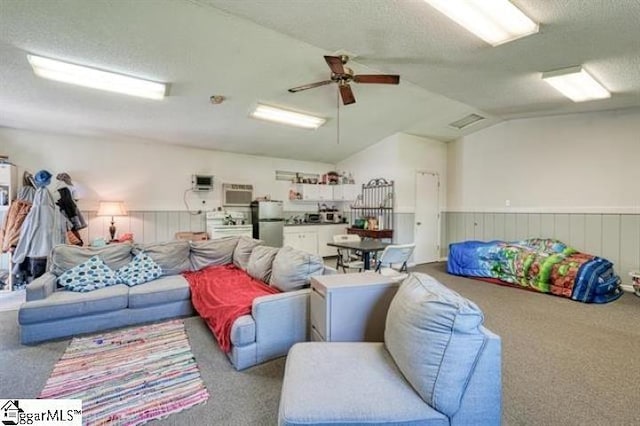 living room featuring light carpet, vaulted ceiling, and a textured ceiling