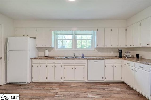 kitchen featuring sink, white appliances, light hardwood / wood-style flooring, and white cabinets