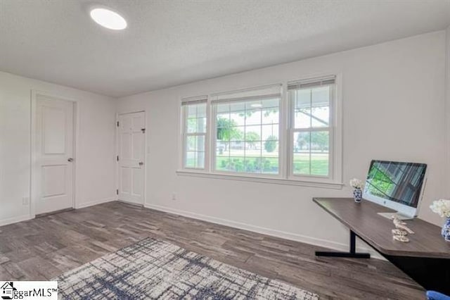 home office featuring hardwood / wood-style floors and a textured ceiling