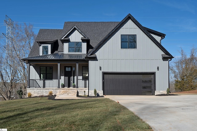 modern inspired farmhouse with a garage, a front yard, and a porch