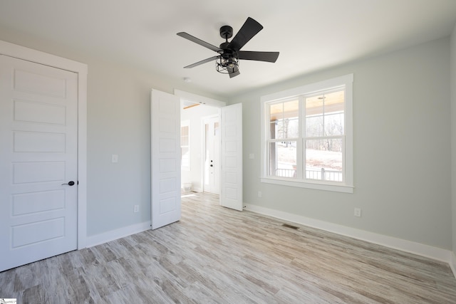 unfurnished bedroom with ceiling fan and light wood-type flooring