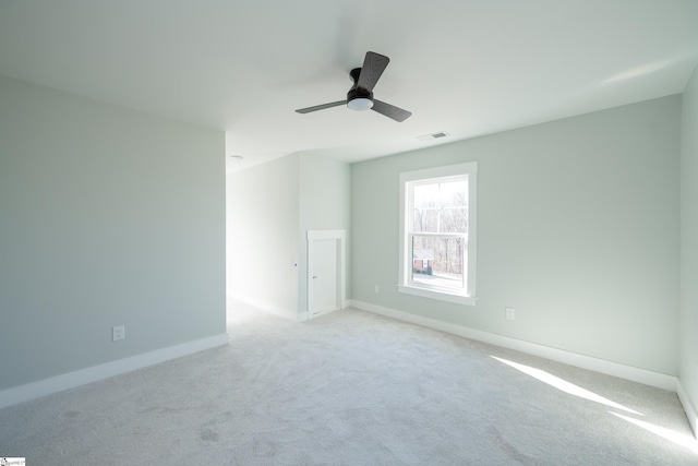 unfurnished room featuring light carpet and ceiling fan