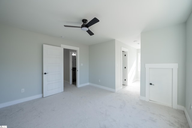 empty room featuring light colored carpet and ceiling fan