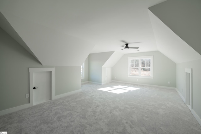 bonus room featuring vaulted ceiling and light carpet