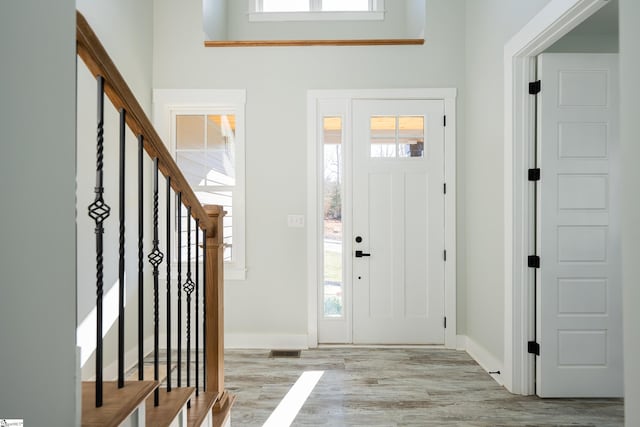 foyer entrance featuring light hardwood / wood-style flooring and plenty of natural light