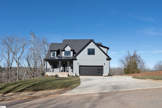 modern farmhouse with a garage, covered porch, and a front lawn