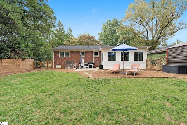 back of property with cooling unit, a yard, and a patio area