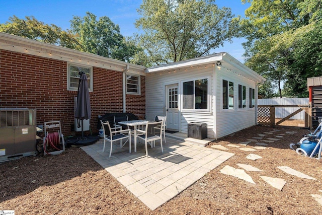 rear view of house with central AC and a patio