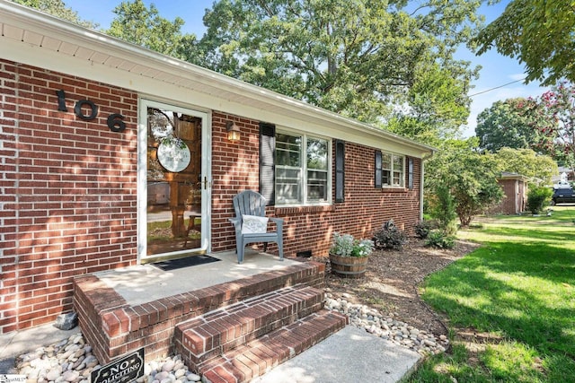 doorway to property with a yard