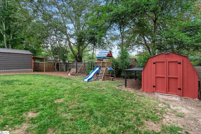 view of yard with a storage shed and a playground