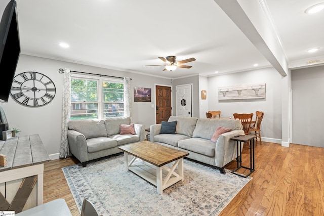 living room with crown molding, ceiling fan, and light hardwood / wood-style flooring