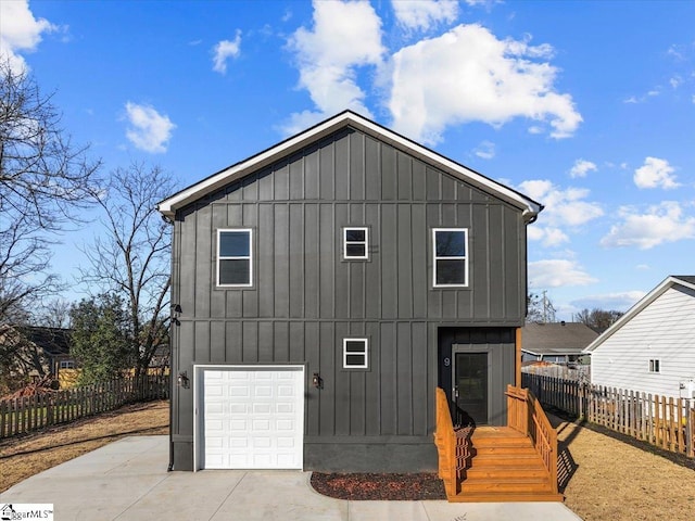 rear view of house with a garage