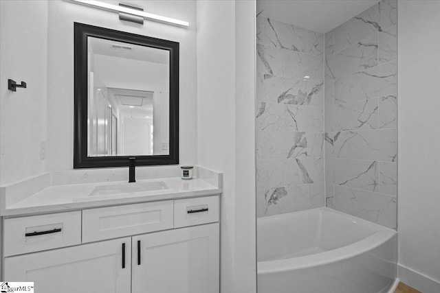 bathroom with tiled shower / bath and vanity