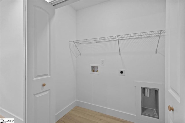 washroom featuring hardwood / wood-style floors, hookup for an electric dryer, and washer hookup