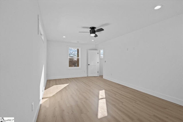 spare room featuring ceiling fan and light hardwood / wood-style flooring