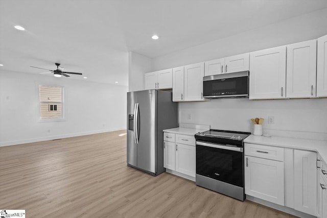 kitchen featuring white cabinetry, stainless steel appliances, and light hardwood / wood-style floors