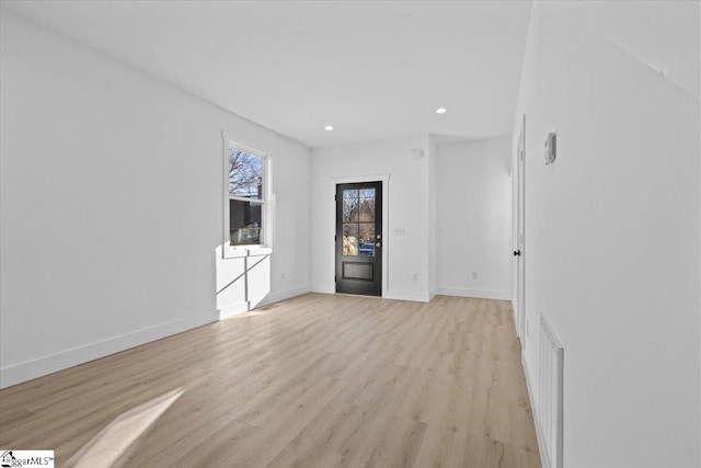 unfurnished room featuring light hardwood / wood-style floors