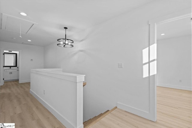 corridor with light hardwood / wood-style floors