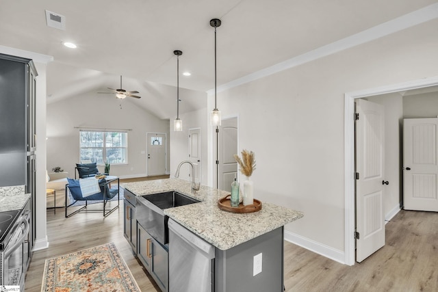 kitchen featuring sink, a center island with sink, pendant lighting, stainless steel appliances, and light hardwood / wood-style floors